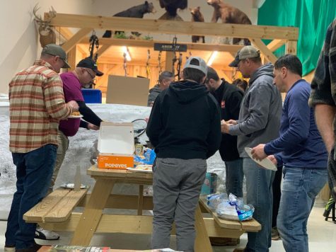 Hunters line up for food at their potluck at Ohio Premier Archery and Sports. 